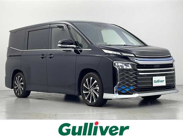 トヨタ ヴォクシー S－Z 愛知県 2022(令4)年 1.6万km アティチュードブラックマイカ 禁煙車/モデリスタシグネチャーイルミグリル/モデリスタイルミルーフスポイラー/トヨタセーフティセンス/・プリクラッシュセーフティ/・レーントレーシングアシスト/・レーンディパーチャーアラート/・オートマチックハイビーム/・ロードサインアシスト/・レーダークルーズコントロール/純正10.5インチディスプレイオーディオ/・AM/FM/CD/DVD/フルセグ/Bluetooth/USB/HDMI/バックカメラ/両側パワースライドドア/前席シートヒーター/ハーフレザーシート/純正ドライブレコーダー/電動パーキング/LEDヘッドライト/オートライト/ETC2.0/純正17インチアルミホイール