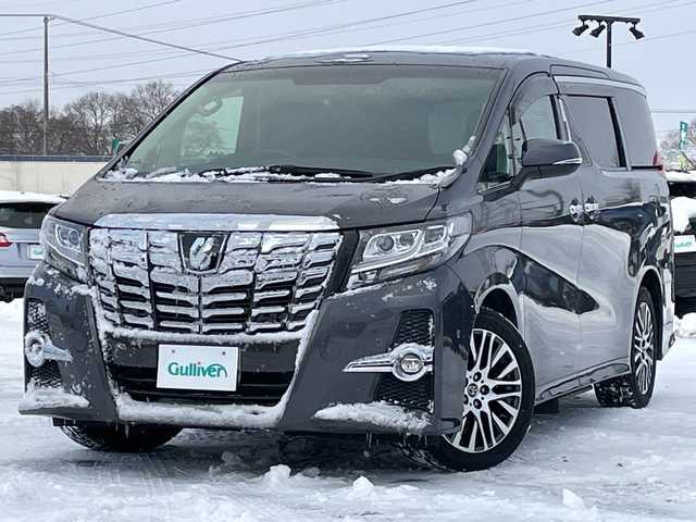 トヨタ アルファード S Cパッケージ 道央・札幌 2015(平27)年 6.9万km グレーメタリック ４WD/JBLプレミアムサウンド/純正メモリーナビ/AM/FM/BT/SD/CD/フルセグ/純正フリップダウンモニター/トヨタセーフティセンス/衝突被害軽減ブレーキ/横滑り防止装置/レーダークルーズコントロール/レーンキープアシスト/パーキングアシスト/クリアランスソナー/バックカメラ/ビルトインETC/ドライブレコーダー/アイドリングストップ/ECOMODE/両側パワースライドドア/パワーバックドア/前席/2列目パワーシート/D席メモリーシート/N席/2列目オットマン/ハーフレザーシート/革巻きウッドコンビステアリング/ステアリングリモコン/ハンドルヒーター/AC100V/電動パーキング/ブレーキホールド/自動防眩ミラー/MTモード付AT/プッシュスタート/スマートキー/LEDヘッドライト/オートライト/フォグランプ/電動格納ミラー/ウィンカーミラー/純正フロアマット/ドアバイザー/スペアキー