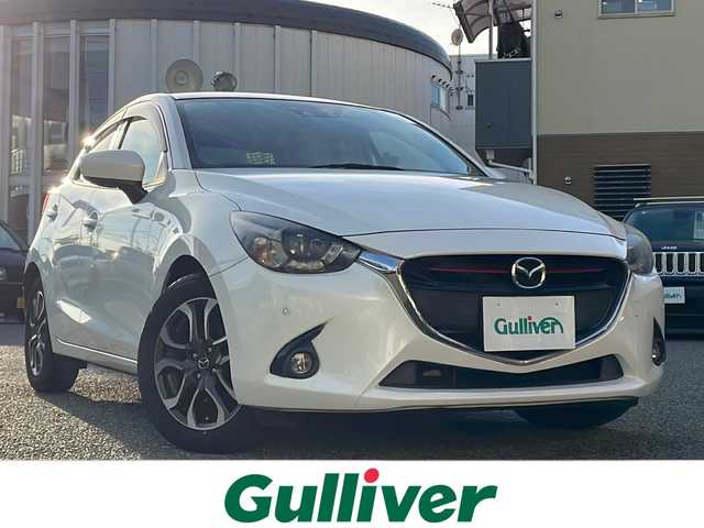 マツダ デミオ XD ツーリング 大阪府 2015(平27)年 14万km スノーフレイクホワイトパールマイカ ワンオーナー/純正メモリナビ/・DVD/CD/FM/AM/Bluetooth/・フルセグテレビ/ETC/ドライブレコーダー/バックカメラ/レーンキープアシスト/クルーズコントロール/盗難防止装置/革巻きステアリング/ステアリングリモコン/パドルシフト/コーナーセンサー/LEDヘッドライト/オートライト/オートエアコン/ドアバイザー/ヘッドアップディスプレイ/スマートキー×2/プッシュスタート/12V電源/USBジャック/純正16インチアルミホイール/純正フロアマット/取扱説明書/保証書