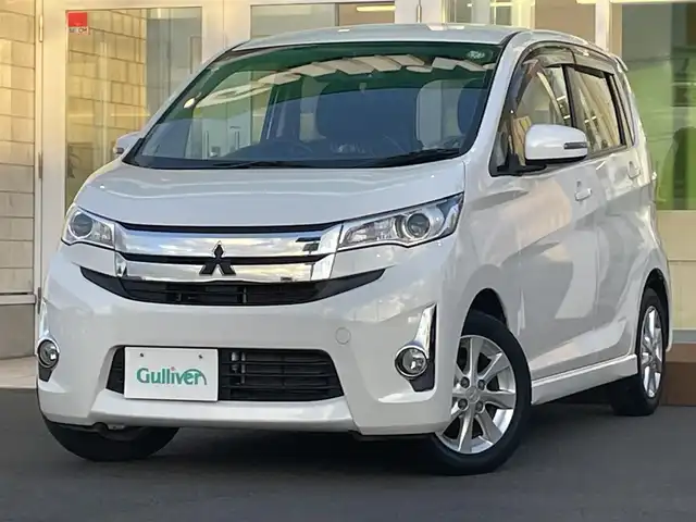 三菱 ｅＫカスタム G 道央・札幌 2014(平26)年 1.9万km シルキーホワイト ４WD/純正オーディオ/（CD/ラジオ）/自動防眩ルームミラー/バックカメラ/純正エンジンスターター/スマートキー/スペアキー/電動格納ミラー/ウィンカーミラー/純正AW夏タイヤ/社外AWスタッドレスタイヤ積込/シートヒーター/アイドリングストップ/プッシュスタート/革巻きステアリング/取扱説明書/保証書/記録簿
