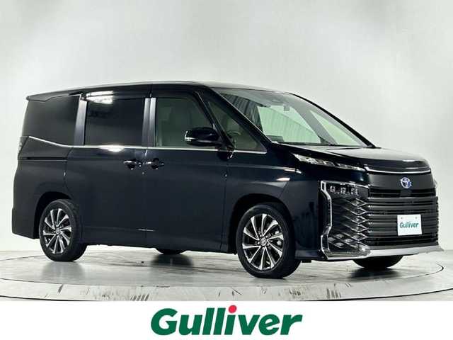 トヨタ ヴォクシー ハイブリッド S－Z 佐賀県 2022(令4)年 2.1万km アティチュードブラックマイカ 快適利便パッケージ/プロジェクター式LEDヘッドライト/純正10.5インチディスプレイオーディオ/ナビキット/フルセグ/CD/DVDデッキ/ビルトインETC2.0/ドライブレコーダー/両側パワースライドドア/パワーバックドア/シートヒーター/オットマン/トヨタセーフティセンス/プリクラッシュセーフティ/レーントレーシングアシスト/レーダークルーズコントロール/アダプティブハイビームシステム/クリアランスソナー