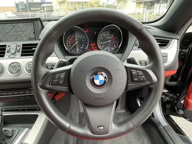 ＢＭＷ Ｚ４ sDrive20i 静岡県 2012(平24)年 1.8万km 黒 電動オープン/レッドレザー/Mスポーツパッケージ/・Mスポーツエアサスペンション/・スポーツレザーステアリングホイール/・アンソラジットルーフライニング/・Mライトアロイホイールスタースポークスタイリング/・スポーツシート/・アルミニウムカーボンインテリアトリム/・ドアシルプレート/・Mフットレスト/シートヒーター/純正ナビ/(FM/AM/AUX/CD/DVD)/ESC/HIDライト/純正18インチアルミホイール/純正フロアマット/オートライト/ETC/保証書/取扱説明書