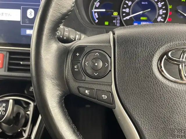 トヨタ ヴォクシー ハイブリッド ZS 煌Ⅱ 愛知県 2019(平31)年 6万km イナズマスパーキングブラックガラスフレーク 禁煙車/純正10インチナビ/（CD/DVD/Bluetooth/フルセグTV/HDMI/USB)/バックカメラ/フリップダウンモニター/トヨタセーフティセンス/・プリクラッシュセーフティ/・レーンディパーチャーアラート/・オートマチックハイビーム/クルーズコントロール/前後ドライブレコーダー/ETC/シートヒーター/両側パワースライドドア/スマートキー/エンジンスターター/プッシュスタート/純正16インチアルミホイール/LEDヘッドライト/フロントフォグランプ/純正フロアマット/横滑り防止装置