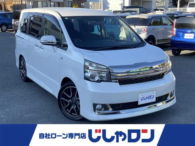 トヨタ ヴォクシー ZS G’sバージョンEDGE 山梨県 2010(平22)年 12.3万km ホワイトパールクリスタルシャイン (株)IDOMが運営する【じしゃロン甲府店】の自社ローン専用車両になります。/こちらは現金またはオートローンご利用時の価格です。自社ローンご希望の方は別途その旨お申付け下さい/スマートキー/両側パワースライドドア/純正ＨＤＤナビ・フルセグＴＶ/Ｂカメラ/ビルトインＥＴＣ/ＨＩＤオートライト/保証書・取説書