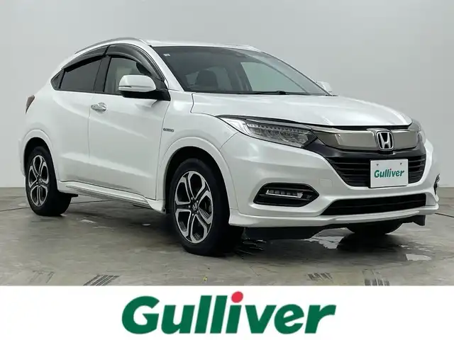 ホンダ ヴェゼル ハイブリッド Z ホンダセンシング 岡山県 2020(令2)年 5万km プラチナホワイトパール 純正8インチナビ/・バックカメラ/・FM/AM/Bluetooth/フルセグ/CD/DVD/HDMI/ホンダセンシング/・衝突軽減ブレーキ/・車線維持支援システム/・アダプティブクルーズコントロール/ハーフレザーシート/・D/Nシートヒーター/パドルシフト/ステアリングスイッチ/ISOFIX/チルトステアリング/シートリフター/ウィンカーミラー/ビルトインETC/純正17インチアルミ/純正フロアマット/LEDヘッドライト/社外ドアバイザー