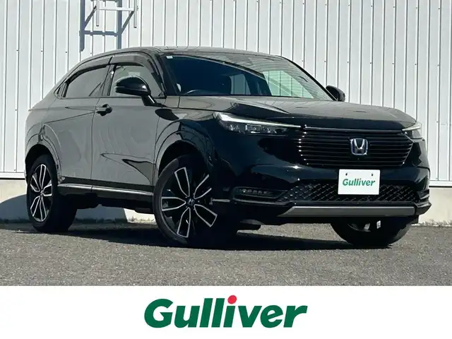 ホンダ ヴェゼル ハイブリッド e:HEV Z 熊本県 2021(令3)年 5万km クリスタルブラックパール 純正メモリナビ/AM/FM/BT/Applecarplay/AndroidAuto/フルセグTV/ビルトインETC2，0/バックカメラ（全周囲）/ドライブレコーダー（前後）/ABS/横滑り防止装置/路外逸脱抑制機能/ブラインドスポットインフォメーション/コーナーセンサー/踏み間違い衝突軽減システム/衝突軽減ブレーキ/ダウンヒルアシストコントロール/電動リアゲート/置くだけ充電/電子パーキング/ブレーキホールド/ハーフレザーシート/シートヒーター（D/N)/純正革巻きステアリング/ステアリングスイッチ/ステアリングパドル/電動格納ミラー/ウィンカーミラー/LEDヘッドライト/オートライト/オートマチックハイビーム/フォグランプ/トノカバー/ドアバイザー/純正フロアマット