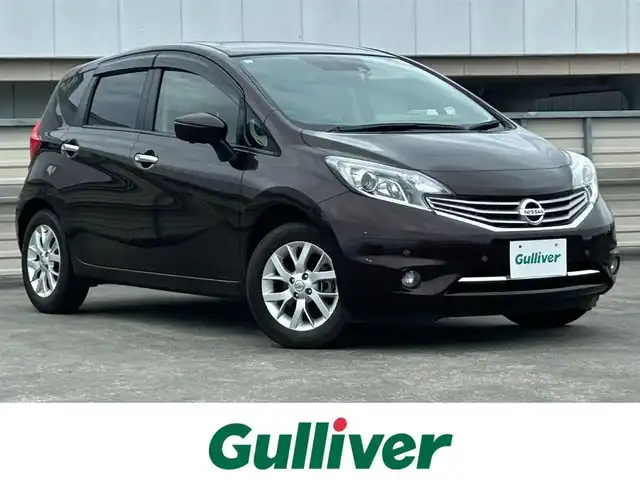 日産 ノート メダリスト エマージェンシーB 静岡県 2015(平27)年 1.7万km インペリアルアンバーP 純正7インチナビ/（Bluetooth/DVD/FM/AM/HDMI）/フルセグTV/VDC（ビークルダイナミクスコントロール）/全周囲カメラ/ETC車載器/ハーフレザーシート/スペアタイヤ/本革巻きステアリング/スマートキー/プッシュスタート/純正15AW
