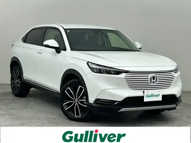 ホンダ ヴェゼル ハイブリッド e:HEV Z 道央・札幌 2024(令6)年 0.7万km プラチナホワイトパール ・４ＷＤ/・衝突軽減/・寒冷地仕様/・社外ディスプレイオーディオ/・BT/CD/USB/・バックカメラ/・ステアリングヒーター/・パワーバックドア/・ブレーキホールド/・ブラインドスポットモニター/・ハンドル支援/・パドルシフト/・ワイパーレベライザー/・アダプティブクルーズコントロール/・レーンキープアシスト/・ダウンヒルアシスト/・シートヒーター/・アイドリングストップ/・ダウンヒルアシスト/・LEDヘッドライト/・オートライト/・社外フロアマット/・革巻きステアリング/・パワーウィンドウ/・パワーステアリング/・ハーフレザーシート
