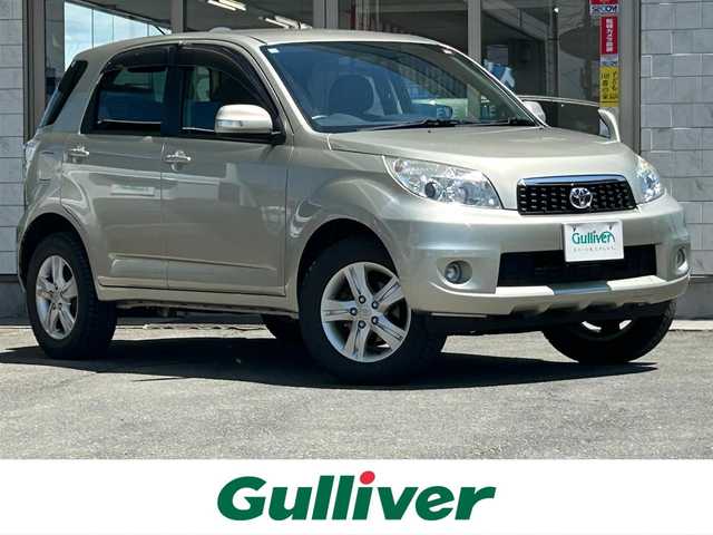 トヨタ ラッシュ G 岩手県 2012(平24)年 9.2万km シャンパンゴールドメタリック 4WD /ワンオーナー /純正オーディオ /キーレス /革ステアリング /電格ミラー/フォグランプ /ヘッドライトレベライザー /リアプライバシーガラス/リアワイパー/ステアリングスイッチ/運転席シートリフター/社外AW17インチ夏タイヤ積込/ドアバイザー/フロアマット/スペアキー×2（鍵のみ）/保証書 取説