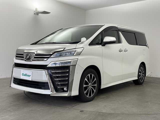 トヨタ ヴェルファイア ZG 兵庫県 2018(平30)年 13.9万km ホワイトパールクリスタルシャイン ・純正SDナビ/　Bluetoothオーディオ　/　CD/DVD再生/　SDミュージックサーバー/　フルセグテレビ/・バックカメラ/・ビルドインETC2.0/・フリップダウンモニター/・Toyota Safety Sense/　プリクラッシュセーフティ/　レーンディパーチャーアラート/　オートマチックハイビーム/・先行車発進告知機能/・パーキングサポートブレーキ（前後方静止物）/・車両接近通報装置/・レザーシート/・シートヒーター/・エアシート
