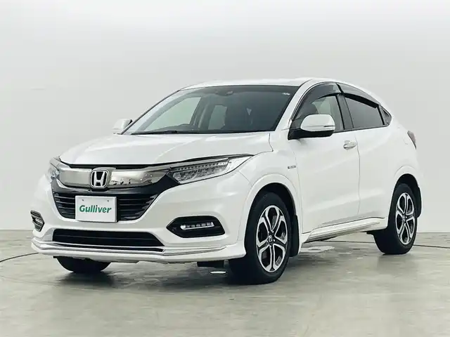 ホンダ ヴェゼル ハイブリッド Z ホンダセンシング 福島県 2019(平31)年 7.1万km プラチナホワイトパール ホンダセンシング/・CMBS/・ACC/・先行車発進告知/・路外逸脱抑制/・レーンアシスト/・リアアクティブフォースペダル/・標識認機能/４ＷＤ　/純正メモリナビゲーション/【AM/FM/DVD/CD/Bluetooth/フルセグ/HDMI】　/型番:VXM-187VFI/ＥＴＣ/ドライブレコーダー　/ハーフレザーシート　/電子パーキング　/・ブレーキホールド　/シートヒーター　/エンジンスターター　/・プッシュスタート　/・スマートキー/LEDライト/・オートライト/・フォグライト/純正フロアマット/ドアバイザー/電動格納ウィンカーミラー/パドルシフト/取扱説明書/・保証書