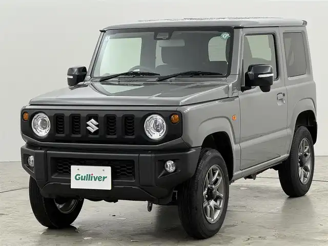 スズキ ジムニー XC 福岡県 2024(令6)年 0.7万km ミディアムグレー 衝突軽減　/レーンキープ　/４ＷＤ　/ＭＴモード付　/クルーズコントロール　/ヒルディセントコントロール　/アイドリングストップ　/シートヒーター　/ヒーテッドドアミラー　/ヘッドライトウォッシャー　/純正アルミホイール