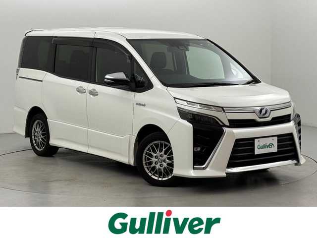 トヨタ ヴォクシー ハイブリッド ZS 煌 福岡県 2019(平31)年 4.4万km ホワイトパールクリスタルシャイン 後席モニター　/純正１０型ナビ　/バックカメラ　/両側パワースライドドア　/ＥＴＣ　/前後ドライブレコーダー　/クルーズコントロール　/衝突軽減　/レーンキープ　/コーナーセンサー　/シートヒーター　/純正ＡＷ　/ＬＥＤ