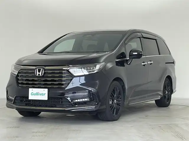 ホンダ オデッセイ ハイブリッド e:HEVアブソルート EXブラックED 群馬県 2023(令5)年 1.3万km プレミアムヴィーナスブラックP 純正15.6インチフリップダウンモニター/＝＝＝＝＝/純正11.インチナビ/・AM/FM/CD/DVD/SD/Bluetooth/・USB/HDMI/AppleCarPlay/AndroidAuto/マルチビューカメラシステム/ホンダセンシング/・衝突軽減ブレーキ/近距離衝突軽減ブレーキ/・先行車発進お知らせ機能/・歩行者事故低減ステアリング/・路外逸脱抑制機能/・渋滞追従機能付アダプティブクルーズコントロール/・車線維持支援システム/・ブラインドスポットインフォメーション/・オートハイビーム/・標識認識機能/・誤発進抑制機能/後方誤発進抑制機能/・急アクセル抑制機能/後退出庫サポート/・パーキングセンサーシステム/両側パワースライドドア/ハンズフリーアクセスパワーテールゲート(予約ロック付)/本革シート/2列目両側アームレスト付4ウェイパワーシート(リクライニング/オットマン)/ひし2列目シートセンターテーブル(折りたたみ式・ドリンクホルダー付)/運転席8ウェイ 助手席4ウェイ パワーシート/運転席＆助手席シートヒーター＋2列目シートヒーター/18インチアルミホイール(マットベルリナブラック)