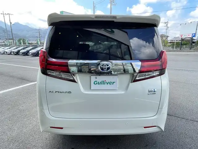 トヨタ アルファードハイブリット G Fパッケージ 愛媛県 2015(平27)年 9.8万km ラグジュアリーホワイトパールクリスタルシャインガラスフレーク 1オーナー/ツインサンルーフ/ALPINE専用10型ナビ【EX10】/　CD/DVD/Bluetooth/HDMI/フルセグTV/ガイド付きバックカメラ/ALPINE12.8型フリップダウンモニター/両側パワースライドドア/衝突被害軽減ブレーキ/クルーズコントロール/ステアリングヒーター/ベージュレザーシート/前席パワーシート(D席メモリー付)/前席シートヒーター/N席2列目オットマン/AC100Vアクセサリー/オートマチックハイビーム/オートライト/LEDヘッドライト/パワーバックドア/ビルトインETC/前後ドライブレコーダー/プッシュスタート/スペアキー×1/取説書