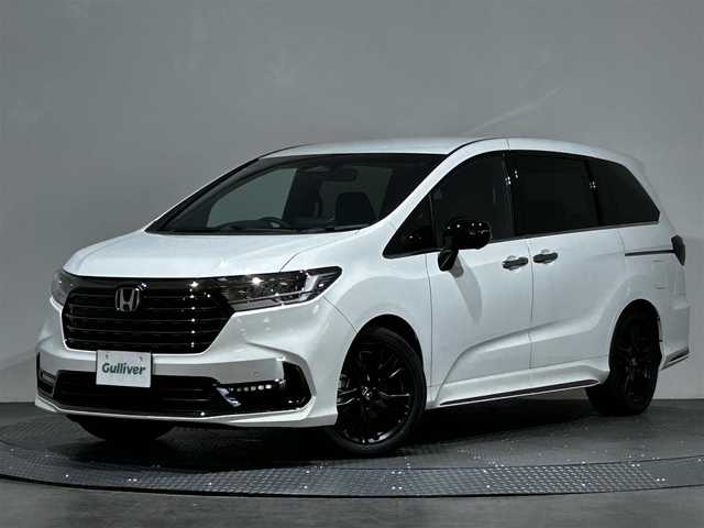 ホンダ オデッセイ ハイブリッド e:HEVアブソルート EXブラックED 三重県 2023(令5)年 0.2万km プラチナホワイトパール 純正１１インチナビ/CD/DVD/BT/MSV/フルセグTV/HDMI/マルチビューカメラ　/両側パワースライドドア　/本革シート　/オットマン　/シートヒーター　/ワイヤレス充電　/ＬＥＤヘッドライト/レーダークルーズコントロール/パワーバックドア/BSM/クリアランスソナー/スペアキー有り