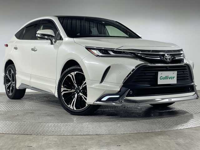 トヨタ ハリアー Z レザーパッケージ 神奈川県 2020(令2)年 5.1万km ホワイトパールクリスタルシャイン 4WD/調光パノラマルーフ/モデリスタエアロ【グランブレイズスタイル】【フロント/サイド/リアアンダー】/モデリスタ20インチアルミホイール/JBLプレミアムサウンドシステム/12.3型ディスプレイオーディオ/Tコネクトナビ/フルセグ　AM FM USB　Bluetooth　AUX/パノラミックビューモニター/デジタルインナーミラー/カラーヘッドアップディスプレイ/パワーバックドア/トヨタセーフティセンス/全車速追従機能付きクルーズコントロール/プリクラッシュセーフティー/レーントレーシングアシスト/アダプティブハイビームシステム/プロアクティブドライビングアシスト/ロードサインアシスト/ドライバー異常時対応システム/発進遅れ告知機能/ブラインドスポットモニター/リヤシートマインダー/フロントリアパーキングセンサー/本革シート/前席シートヒーター/パワーシート/運転席ポジションメモリー/革巻きステアリング/ステアリングヒーター/オートブレーキホールド/電動パーキング/プッシュスタート/スマートキー/LEDヘッドランプ/オートライト/純正リアスポイラー