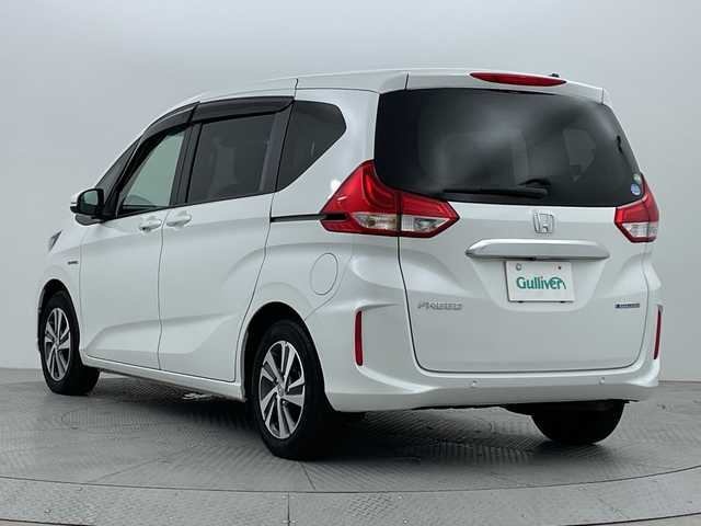 ホンダ フリード ハイブリット G ホンダセンシング 新潟県 2020(令2)年 3.9万km プラチナホワイトパール ワンオーナー　/バックモニター　/フルセグＴＶ(走行中視聴可能)　/メモリナビ(AM/FM/CD/DVD/BT)　/Ｂｌｕｅｔｏｏｔｈ接続　/ＡＷ付きスタッドレスタイヤ/ステアリングスイッチ　/両側パワースライドドア　/運転席助手席シートヒーター　/追従型クルーズコントロール　/保証書/取扱説明書/記録簿