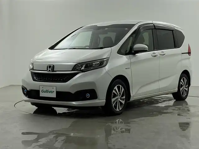 ホンダ フリード ハイブリット G ホンダセンシング 福井県 2019(令1)年 4.6万km プラチナホワイトパール Sパッケージ/-本革巻きステアリング/-コンビシート&専用インテリア/-15インチアルミホイール/-シートバックアッパーポケット/純正9インチプレミアムインターナビ/-AM/FM/DVD/BT/USB/HDMI/フルセグTV/純正ドライブレコーダー前後/純正フロアマット/両側パワースライドドア/バックカメラ/ETC/ハーフレザーシート/シートヒーター/衝突被害軽減システム/レーダークルーズコントロール/レーンキープアシスト/横滑り防止装置/アイドリングストップ/オートLEDライト/ステアリングスイッチ