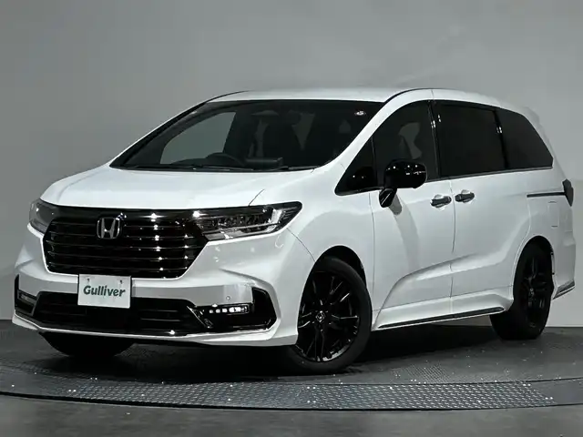 ホンダ オデッセイ ハイブリッド e:HEVアブソルート EXブラックED 愛媛県 2023(令5)年 0.3万km プラチナホワイトパール 純正１１インチナビ（フルセグＴＶ　Ｂｌｕｅｔｏｏｔｈ　ＣＤ　ＤＶＤ　ＳＤ）マルチビューカメラ　本革シート　両側パワースライドドア　オットマン　ＥＴＣ　シートヒーター　ワイヤレス充電　ＬＥＤヘッド