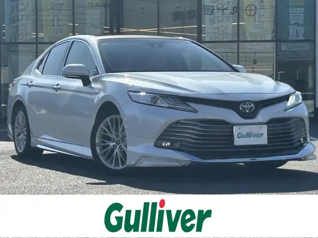 トヨタ カムリ G レザーパッケージ 岡山県 2018(平30)年 10.1万km プラチナホワイトパールマイカ 登録時走行距離101062km/パノラマルーフ/モデリスタフルエアロ/純正8インチナビ/フルセグTV(AM/FM/CD/DVD/Bluetooth)/バックカメラ/ビルトインETC/ヘッドアップディスプレイ/トヨタセーフティセンス/・レーダークルーズコントロール/・オートマチックハイビーム/・プリクラッシュセーフティ/・レーンディバーチャーアラート/横滑り防止装置/電子パーキング/オートブレーキホールド/D/N席パワーシート/D/N席シートヒーター/本革シート/純正フロアマット/18インチ純正AW
