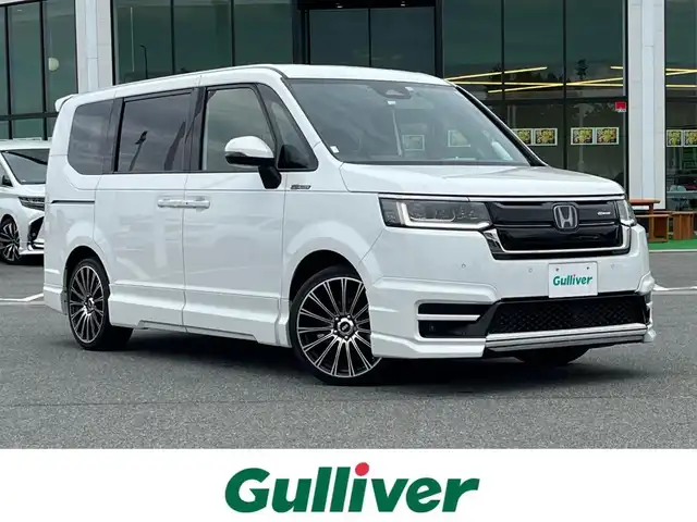 ホンダ ステップワゴン スパーダ eHEV 奈良県 2022(令4)年 2.7万km プラチナホワイトパール 無限フルエアロ/無限フロントグリル/純正ナビ（LXM-237VFNi)/（TV/BT/CD/DVD/AppleCarPlay/AndroidAuto)/純正10インチフリップダウンモニター（VM-221T）/レーダークルーズコントロール/バックカメラ/パドルシフト/ブラインドスポットモニター/前後コーナーセンサー/衝突軽減システム/レーンキープアシスト/両側パワースライドドア/パワーバックドア/ハーフレザーシート/前席シートヒーター/後席サンシェード/純正前方ドライブレコーダー/ETC/無限19インチＡＷ/スペアキーＸ１