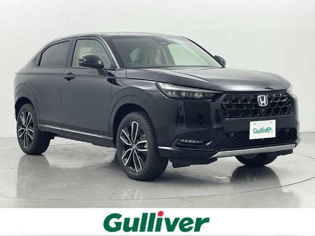 ホンダ ヴェゼル ハイブリッド e:HEV Z 熊本県 2025(令7)年 0.1万km未満 クリスタルブラックパール 登録済未使用車/純正ナビ（ＡｐｐｌＣａｒＰｌａｙ・ＡｎｄｒｏｉｄＡｕｔｏ・ＵＳＢ・ＢＴ・フルセグ）/ビルトインＥＴＣ２．０　/前後クリアランスソナー　/ホンダセンシング/・衝突軽減ブレーキ/・踏み間違い防止/・急アクセル抑制機能/・路外逸脱抑制機能/・歩行者事故低減ステアリング/・アダブティブクルーズコントロール/・車線維持支援システム/・先行車発進お知らせ/・標識認識システム/・ブラインドスポットモニター/・オートマチックハイビーム/ダウンヒルアシスト/横滑り防止/パワーバックドア/前席シートヒーター/ステアリングヒーター/置くだけ充電/パドルシフト/ハーフレザーシート/純正１８インチAW/オートライト/LEDヘッドライト/フォグライト/スマートキー/プッシュスタート/スペアキー1本/取扱説明書