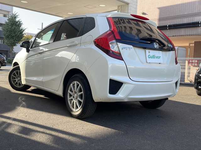 ホンダ フィット 13G Fパッケージ 道央・札幌 2014(平26)年 9.4万km プレミアムホワイトパール 純正ナビ/バックカメラ/ETC/オートライト/アイドリングストップ/電動格納ミラー/純正マット/横滑り防止