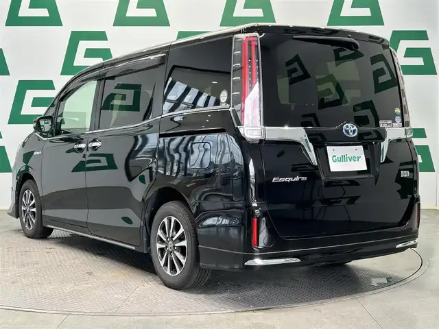 トヨタ エスクァイア ハイブリッド Gi プレミアムパッケージ 鹿児島県 2018(平30)年 7.1万km ブラック 禁煙車/純正ナビ/両側パワースライドドア/全方位ドライブレコーダー（HDR360G）/ビルトインETC/ステアリングヒーター/クルーズコントロール/レーンキープアシスト/TRC/自動防眩インナーミラー/AC100V/LEDヘッドライト/オートマチックハイビーム/純正フロアマット/ハーフレザーシート/後席ロール式サンシェード/後席バックテーブル/ステアリングリモコン/電格ミラー