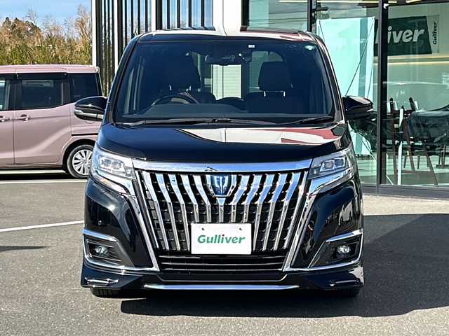 トヨタ エスクァイア ハイブリッド Gi プレミアムパッケージ 鹿児島県 2018(平30)年 7.1万km ブラック ディーラーオプション10インチナビ(NSZN-Z66T)/バックカメラ/フルセグテレビ/CD/DVD/BT/SD/FM.AM/プリクラッシュセーフティ/レーンディパーチャーアラート/オートマチックハイビーム/先行車発信告知/クルーズコントロール/両側パワースライドドア/ステアリングスイッチ/社外360度録画型ドライブレコーダー(HDR360G)/シートヒーター(運転席/助手席)/ビルトインETC/AC100V電源（センターコンソール後方）/前後コーナーセンサー/後席ロールサンシェード/純正フロアマット/純正ドアバイザー/純正15インチアルミホイール/スマートキー×2/エンジンスターター×1/保証書/取扱説明書