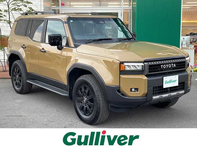 トヨタ ランドクルーザー ２５０ VX ファーストエディション 青森県 2024(令6)年 0.3万km ベージュ 4WD/純正12.3型DAナビ・フルセグTV/JBLプレミアムサウンド/Bluetooth・USB・HDMI・ミラキャスト/パノラミックビューモニター/ムーンルーフ/茶革シート/前席ベンチレーション・ヒーター/運転席パワーシート/ステアリングヒーター/デジタルインナーミラー/おくだけ充電/パワーバックドア/セーフティセンス/トヨタチームメイト/プリクラッシュセーフティ/レーダークルーズコントロール/レーントレーシングアシスト/レーンディパーチャーアラート/オートマチックハイビーム/ブラインドスポットモニター/純正前後ドライブレコーダー/1～3列目充電用USB端子/純正ファーストエディションフロアマット/3眼LEDヘッドランプ/LEDフォグランプ/LEDリアフォグランプ/ブラックルーフレール/純正18インチアルミ