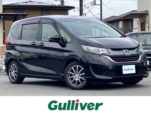 ホンダ フリード ハイブリット EX 静岡県 2017(平29)年 9.6万km クリスタルブラックパール 純正9インチナビ(CD/DVD/BT/フルセグ)/バックカメラ/エンジンスタートボタン/パワーステアリング/パワーウィンドウ/寒冷地仕様/アイドリングストップ/スマートキー/スペアキー１本/オートエアコン/レーダークルーズコントロール/後席モニター(VM-185EN)/純正ETC/ドライブレコーダー/ウォークスルー/社外フロアマット/ハーフレザーシート/D席N席シートヒーター/両側パワースライドドア/社外アルミホイール/ABS/横滑り防止装置/レーンキープアシスト/オートライト/LEDヘッドライト/W+サイドエアバッグ/カーテンエアバッグ/衝突軽減システム/パワステ不調(カクカクする)