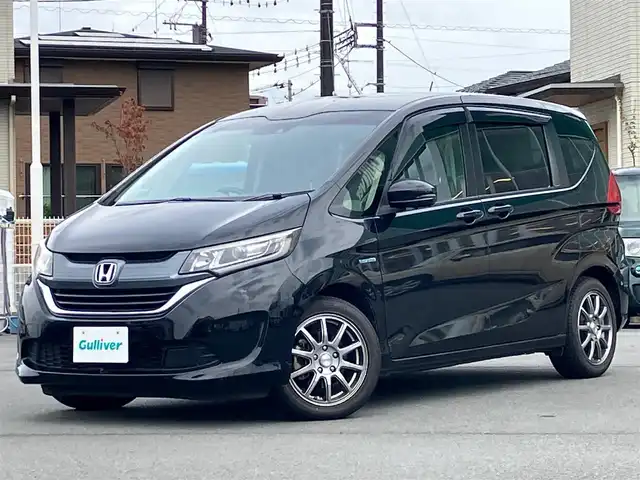 ホンダ フリード ハイブリット EX 静岡県 2017(平29)年 9.6万km クリスタルブラックパール 純正9インチナビ(CD/DVD/BT/フルセグ)/バックカメラ/エンジンスタートボタン/パワーステアリング/パワーウィンドウ/寒冷地仕様/アイドリングストップ/スマートキー/スペアキー１本/オートエアコン/レーダークルーズコントロール/後席モニター(VM-185EN)/純正ETC/ドライブレコーダー/ウォークスルー/社外フロアマット/ハーフレザーシート/D席N席シートヒーター/両側パワースライドドア/社外アルミホイール/ABS/横滑り防止装置/レーンキープアシスト/オートライト/LEDヘッドライト/W+サイドエアバッグ/カーテンエアバッグ/衝突軽減システム/パワステ不調(カクカクする)