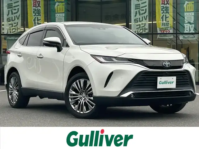 トヨタ ハリアー ハイブリッド Z 岡山県 2020(令2)年 8.4万km ホワイトパールクリスタルシャイン 登録時走行距離83180km/JBLプレミアムサウンド/純正12.3インチナビ/フルセグTV(AM.FM.TV.BT)/全方位カメラ/ETC2.0/ブラインドスポットモニター/デジタルインナーミラー/ヘッドアップディスプレイ/クリアランスソナー/衝突軽減ブレーキ/横滑り防止装置/クルーズコントロール(追従走行あり)/車線逸脱警報（レーンキープアシスト）/オートライト/オートマチックハイビーム/アイドリングストップ/電動リアゲート/19インチ純正AW/純正フロアマット/ハーフレザーシート/D席パワーシート/スマートキー/プッシュスタート/ドアバイザー