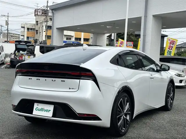 トヨタ プリウス Z 熊本県 2023(令5)年 0.4万km プラチナホワイトパールマイカ 純正ナビ付ディスプレイオーディオ/【フルセグTV/Bluetooth/Miracast】/全周囲カメラ/バックカメラ/レーダークルーズコントロール/プリクラッシュセーフティー/リヤクロストラフィックアラート/パーキングサポートブレーキ/レーンキープアシスト/ロードサインアシスト/コーナーセンサー/ブレーキホールド/パワーバックドア/オートLEDライト/オートマチックハイビーム/ウィンカーミラー/レザーシート/前席シートヒーター/前席エアシート/D席パワーシート/革巻きステアリング/ステアリングスイッチ/ハンドルヒーター/プッシュスタート/スマートキー/ETC2.0/ドライブレコーダー/純正フロアマット/純正ドアバイザー/横滑り防止装置/保証書/スペアキー