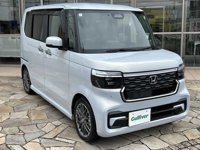 ホンダ Ｎ ＢＯＸ カスタム ターボ 静岡県 2024(令6)年 0.9万km プレミアムサンライトホワイトパール 純正ナビ/・フルセグTV/・Bluetooth/・iPod/・USB/・FM/AM/主要装備/・ＥＴＣ/・追従クルコン/・両側パワスラ/・横滑り防止装置/・ホンダセンシング/・運転席＋助手席シートヒーター/・パドルシフト/・純正切削１５インチアルミホイール/・オートライト/・電動パーキング/・オートホールド　/・ハーフレザー/・本革巻ステアリングホイール