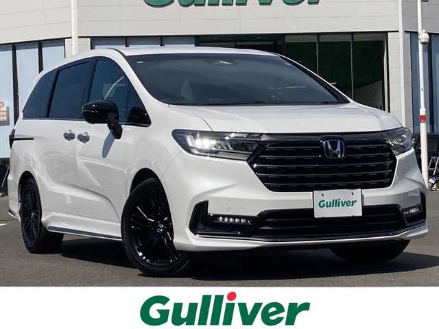 ホンダ オデッセイ ハイブリッド e:HEVアブソルート EXブラックED 佐賀県 2023(令5)年 1.2万km プラチナホワイトパール Gathers11.4インチナビ/Gathers15.6インチフリップダウンモニター/マルチビューモニター/両側パワースライドドア/衝突被害軽減ブレーキ/路線逸脱警報/コーナーセンサー/ブラインドスポットインフォメーション/アダプティブクルーズコントロール/電動パーキングブレーキ/オートブレーキホールド/レザーシート/パワーシート/シートヒーター/オットマン/パワーバックドア/ETC/置くだけ充電/ステアリングリモコン/プッシュスタート/スマートキー/LEDヘッドライト/フォグライト/純正ブラックアルミホイール