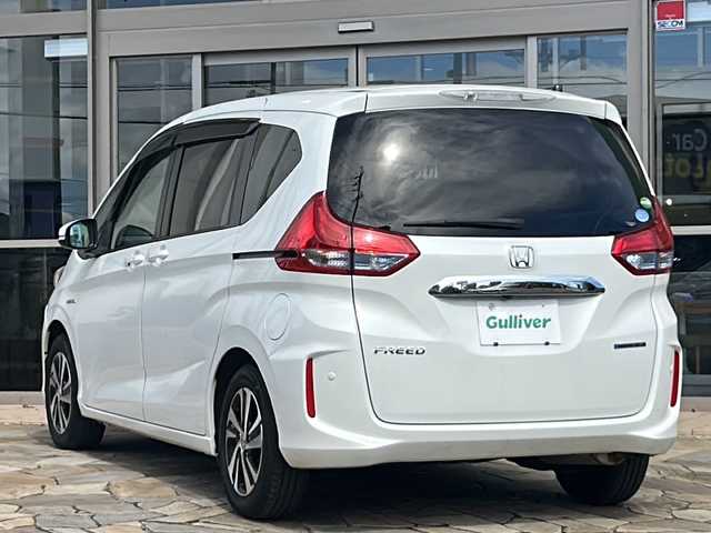 ホンダ フリード ハイブリット G ホンダセンシング 静岡県 2018(平30)年 9.2万km ホワイトオーキッドパール 【安全装備】/ホンダセンシング/アダプティブ・クルーズ・コントロール（ACC）/・作動車速域：約30km/hから100km/h間/車線維持支援システム（LKAS）/・作動車速：約65km/hから100km/h間/・ステアリング制御/衝突軽減ブレーキ（CMBS）/・歩行者検知機能/・作動車速：約80km/h未満時/・対向車車速：約30km/hから80km/h時/誤発進抑制機能（前進）/・ミリ波レーダー検知：作動車速10km/h未満/歩行者事故低減ステアリング/・作動車速10km/hから40km/h間/路外逸脱抑制機能/・作動車速：約60km/hから100km/h間/先行車発進お知らせ機能/標識認識機能/【主要装備】/純正ナビ　/フルセグ　/バックカメラ　/スマートキー　/プッシュスタート　/ＬＥＤヘッドライト　/両側パワースライドドア　/ハーフレザーシート　/ステアリングスイッチ　