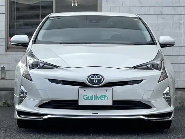 トヨタ プリウス A プレミアム　ツーリングセレ 福岡県 2016(平28)年 9.1万km ホワイトパールクリスタルシャイン モデリスタエアロ(フロント/サイド/リヤ)/純正9インチメモリナビ【DSZT-YC4T】/　(AM/FM/CD/DVD/Bluetooth/フルセグTV)/バックカメラ/トヨタセーフティセンス/・プリクラッシュセーフティ/・レーダークルーズコントロール/・レーンディパーチャーアラート/・オートマッチックハイビーム/ブラインドスポットモニター/シンプルインテリジェントパーキングアシスト/ヘッドアップディスプレイ/横滑り防止/ドライブモードセレクト/純正ビルトインETC/黒レザーシート/革巻きステアリング/ステアリングスイッチ/パワーシート(D)/シートヒーター(D/N)/純正フロアマット/ナノイー/100V電源/ISOFIX/スペアキー×1/保証書/取扱説明書/ナビ取扱説明書