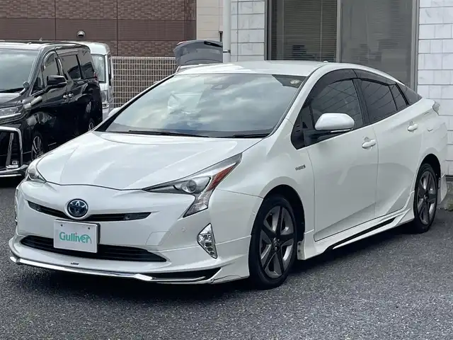 トヨタ プリウス A プレミアム　ツーリングセレ 福岡県 2016(平28)年 9.1万km ホワイトパールクリスタルシャイン モデリスタエアロ(フロント/サイド/リヤ)/純正9インチメモリナビ【DSZT-YC4T】/　(AM/FM/CD/DVD/Bluetooth/フルセグTV)/バックカメラ/トヨタセーフティセンス/・プリクラッシュセーフティ/・レーダークルーズコントロール/・レーンディパーチャーアラート/・オートマッチックハイビーム/ブラインドスポットモニター/シンプルインテリジェントパーキングアシスト/ヘッドアップディスプレイ/横滑り防止/ドライブモードセレクト/純正ビルトインETC/黒レザーシート/革巻きステアリング/ステアリングスイッチ/パワーシート(D)/シートヒーター(D/N)/純正フロアマット/ナノイー/100V電源/ISOFIX/スペアキー×1/保証書/取扱説明書/ナビ取扱説明書