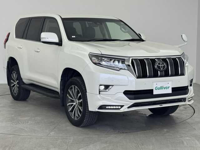 トヨタ ランドクルーザー プラド TX Lパッケージ 愛知県 2019(平31)年 7.2万km ホワイトパールクリスタルシャイン ワンオーナー/4WD/トヨタセーフティセンス/　　・プリクラッシュセーフティ/　　・レーンディバーチャーアラート/　　・レーントレーシングアシスト/　　・レーダークルーズコントロール/　　・オートマチックハイビーム/　　・ロードサインアシスト/　　・クリアランスソナー/TRDエアロセット/　　・フロントスポイラー/　　・リヤバンパースポイラー/アルパイン製9インチナビ/フルセグTV/バックカメラ/レザーシート/シートヒーター（前席）/エアシート（前席）/電動格納サードシート/LEDルームランプ/クリアランスソナー/取扱説明書/保証書
