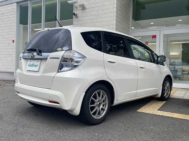 ホンダ フィット ハイブリット 10thアニバーサリー 鳥取県 2012(平24)年 7.9万km プレミアムホワイトパール ＨＤＤナビ/フルセグＴＶ　ＭＳＶ　ＤＶＤ　ＣＤ　ＳＤ　Ｂｌｕｅｔｏｏｔｈ/ＥＴＣ/クルーズコントロール/スマートキー/スペアキー/フロアマット/ドアバイザー/ライトレベライザー/新車保証書/取扱説明書