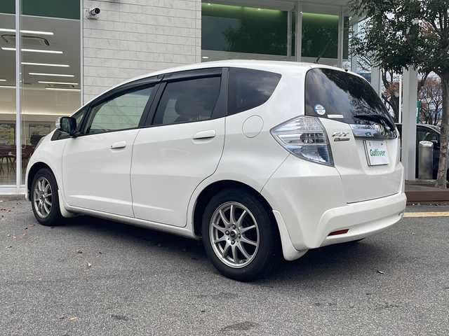 ホンダ フィット ハイブリット 10thアニバーサリー 鳥取県 2012(平24)年 7.9万km プレミアムホワイトパール ＨＤＤナビ/フルセグＴＶ　ＭＳＶ　ＤＶＤ　ＣＤ　ＳＤ　Ｂｌｕｅｔｏｏｔｈ/ＥＴＣ/クルーズコントロール/スマートキー/スペアキー/フロアマット/ドアバイザー/ライトレベライザー/新車保証書/取扱説明書