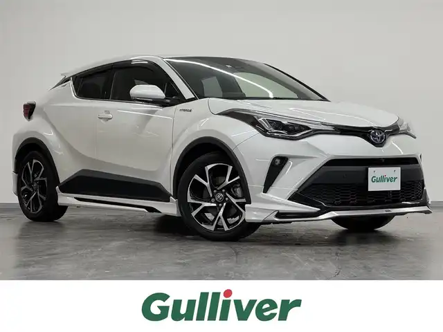 トヨタ Ｃ－ＨＲ G 三重県 2020(令2)年 2.7万km ホワイトパールクリスタルシャイン ハイブリッド/FF/フロアCVT/モデリスタエアロキット（F/S/R下）/純正 8インチディスプレイオーディオ/（AM/FM/USB/Bluetooth/Miracast/CarPlay/AndroidAuto）/【OP】パノラミックビューモニター/ビルトイン ETC/Toyota Safety Sense/・プリクラッシュセーフティ［PCS］/・レーンディパーチャーアラート［LDA］（ステアリング制御付）/・オートハイビーム［AHB］/・レーダークルーズ（全車速追従機能付）/・ブラインドスポットモニター［BSM］/・インテリジェント クリアランスソナー/・リヤクロストラフィックオートブレーキ［パーキングサポートブレーキ（静止物・後方接近車両）］/装備/・【OP】寒冷地仕様/　・ウインドシールドデアイサー、リヤフォグランプ、PTCヒーター、ヒーターリヤダクトなど/・ハーフレザーシート/・シートヒーター（D/N）/・左右独立オートエアコン/・オートライト/・LEDヘッドライト/・LEDフロント&リヤフォグランプ/・雨滴感応式フロントワイパー/・純正18inAW/・保/取/マルチ取/・予備スマートキーx1