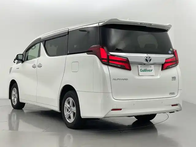 トヨタ アルファードハイブリット X 熊本県 2020(令2)年 2.1万km ホワイトパールクリスタルシャイン ツインムーンルーフ/４WD/純正ナビ（ＣＤ・ＤＶＤ・フルセグ・ＢＴ・ＵＳＢ）/純正フリップダウンモニター　/ビルトインＥＴＣ２．０　/純正前方ドライブレコーダー　/両側パワースライドドア　/前後クリアランスソナー　/トヨタセーフティーセンス/・プリクラッシュセーフティ/・レーンキープアシスト/・駐車時支援パーキングサポート/・アダブティブクルーズコントロール/・ロードサインアシスト/・オートハイビーム/横滑り防止/パワーバックドア/AC100V充電/純正フロアマット/純正16インチAW/オートライト/LEDヘッドライト/フォグライト/スマートキー/プッシュスタート/スペアキー1本