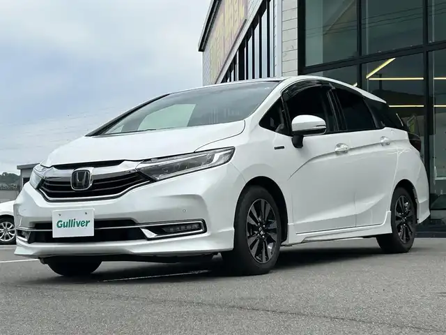 ホンダ シャトル ハイブリッド X ホンダセンシング 愛媛県 2020(令2)年 3.6万km プラチナホワイトパール 純正8型ナビ/バックカメラ/半革温シート/アダプティブクルーズコントロール/衝突被害軽減装置/車線逸脱防止装置/クリアランスソナー/パドルシフト/フロントワイパーデアイサー/前後ドライブレコーダー/LEDヘッドライト/電格ミラー/ヒートミラー/ステアリングリモコン/純正ラバーマット/ISOFIX/シガーソケット/現状サマー(純正AW)(185/60R15)/BRIDGESTONE EcoPia EP150