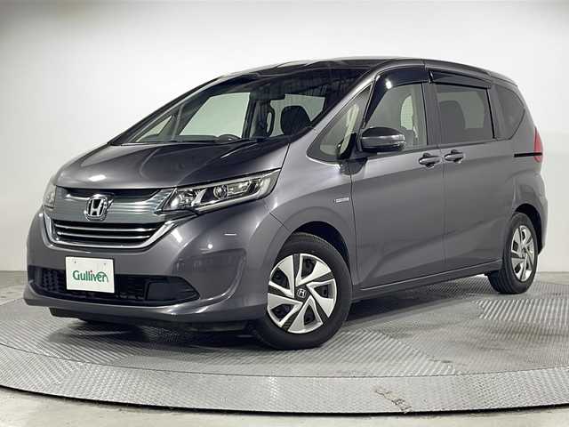 ホンダ フリード ハイブリット G ホンダセンシング 広島県 2020(令2)年 3.6万km モダンスティールM ｓｔｒａｄａナビ/バックカメラ/後席フリップダウンモニター/両側パワースライドドア/ＥＴＣ/レーダークルーズコントロール/衝突被害軽減/レーンキープアシスト/フルセグ/ＤＶＤ/踏み間違い防止/ＬＥＤヘッドライト/純正15インチホイールキャップ(185/65//R15)/エアバッグ(運転席/助手席/サイド/カーテン)