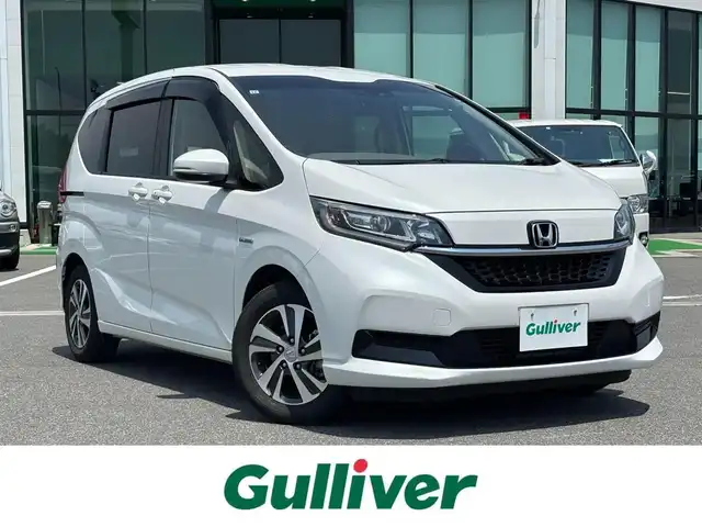 ホンダ フリード ハイブリット G ホンダセンシング 奈良県 2021(令3)年 4.6万km パール ９インチ純正ナビ　/フルセグテレビ　/ｂｌｕｅｔｏｏｔｈ　/ＨＤＭＩ　/バックカメラ　/両側パワースライドドア　/ハーフレザー　/シートヒーター　/フロントガラス熱線スイッチ　　/ビルトインＥＴＣ　/前後社外ドライブレコーダー/2列目テーブル（運転席＋助手席）/USBポート/パーキングセンサーシステム