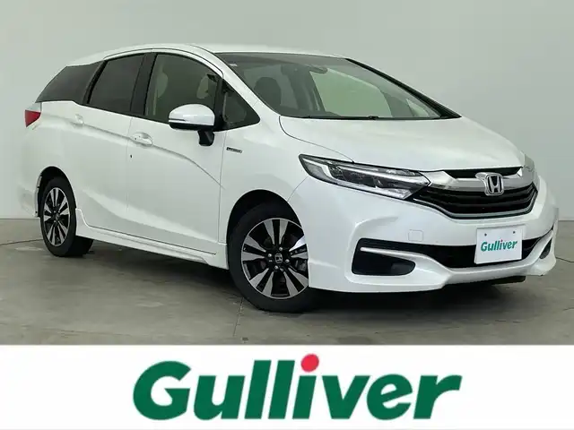 ホンダ シャトル ハイブリッド X 富山県 2015(平27)年 7.4万km ホワイトオーキッドパール 純正ナビ（CD DVD bluetooth）/フルセグTV/HDMI/バックカメラ/ビルトインETC/フロントドラレコ（DRY-AS350GS）/純正15インチAW/15インチスタッドレスセット積込み/パドルシフト/ハーフレザーシート/オートライト/LEDヘッドライト/スマートキー/プッシュスタート/クルーズコントロール/横滑防止装置/純正マット/保証書/スペアキー