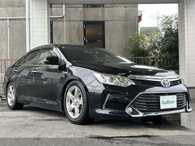 トヨタ カムリ ハイブリット Gパッケージ 京都府 2016(平28)年 10.5万km アティチュードブラックマイカ 純正ＳＤナビ　/（NSZN-W64T、7インチ）/フルセグＴＶ　/禁煙車　/バックカメラ　/Bluetooth/CD/DVD再生機能有/USB/クルーズコントロール/パワーステアリング/パワーウィンドウ　/Ｄ席パワーシート　/後席ベンチシート/スマートキー　/純正ＡＷ１７インチ/前後社外ドライブレコーダー/（CA-XDR50D)　/ウィンカーミラー/フロントフォグランプ/キセノンヘッドライト　/オートライト/電動格納ミラー　/アイドリングストップ　/デュアルエアコン/横滑り防止装置/盗難防止装置/Wサイドエアバッグ/カーテンエアバッグ/衝突被害軽減ブレーキ